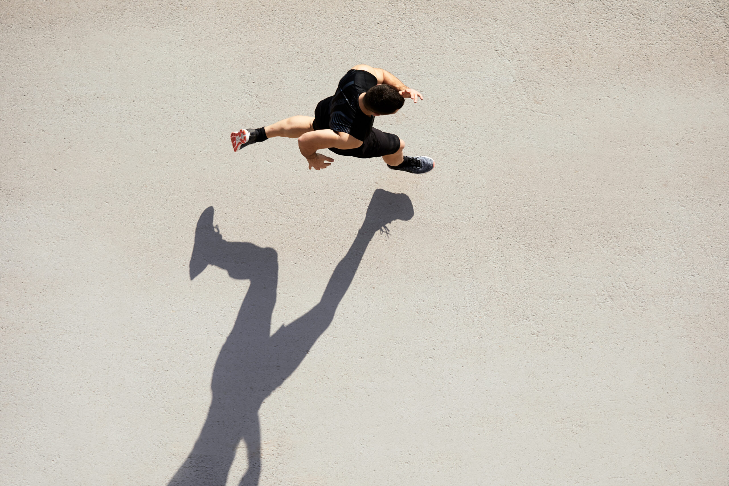Sprinter seen from above with shadow and copy space.