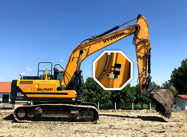 Excavator on building site with NaBi Track device attached