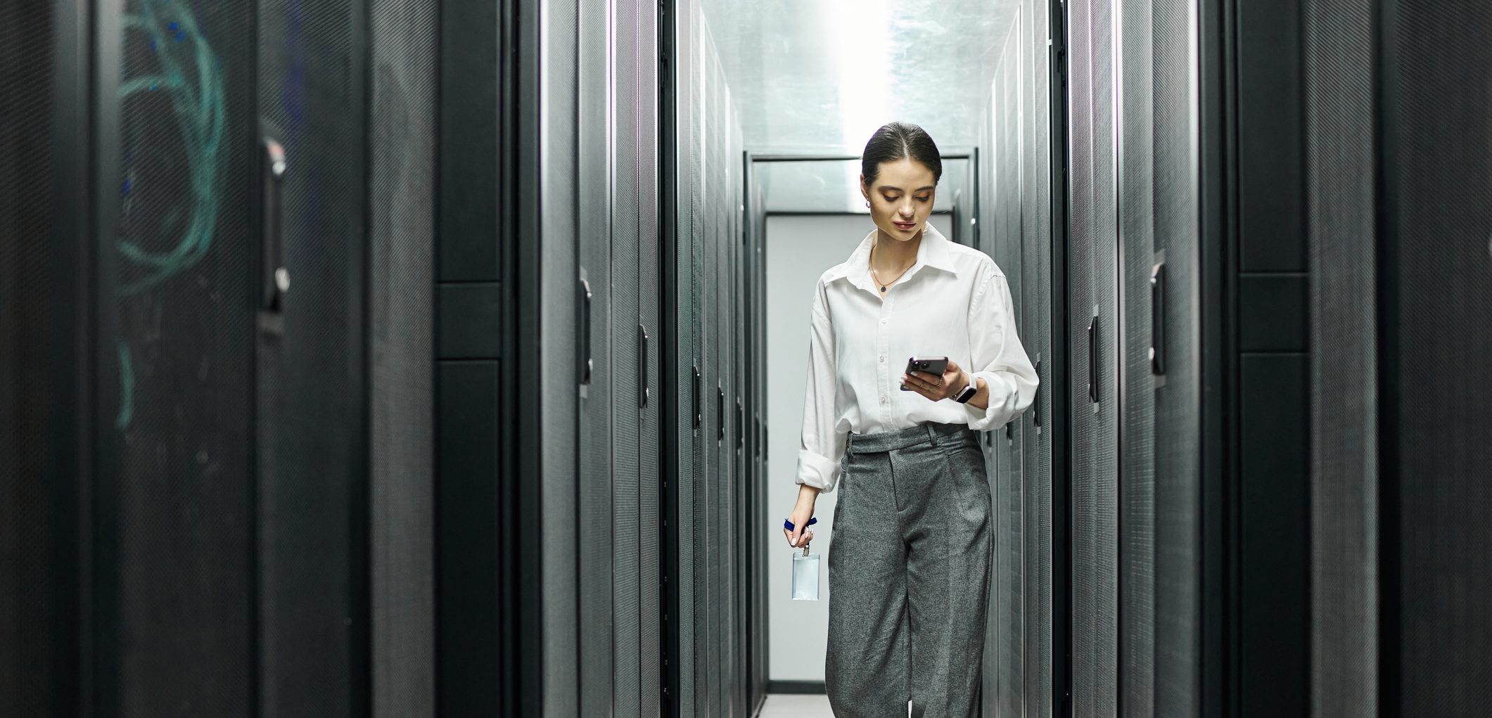 professional-woman-navigating-a-modern-server-room-in-a-data-center