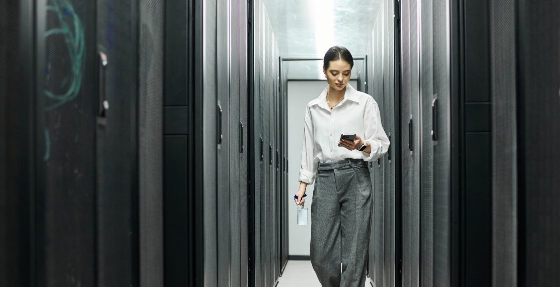 professional-woman-navigating-a-modern-server-room-in-a-data-center