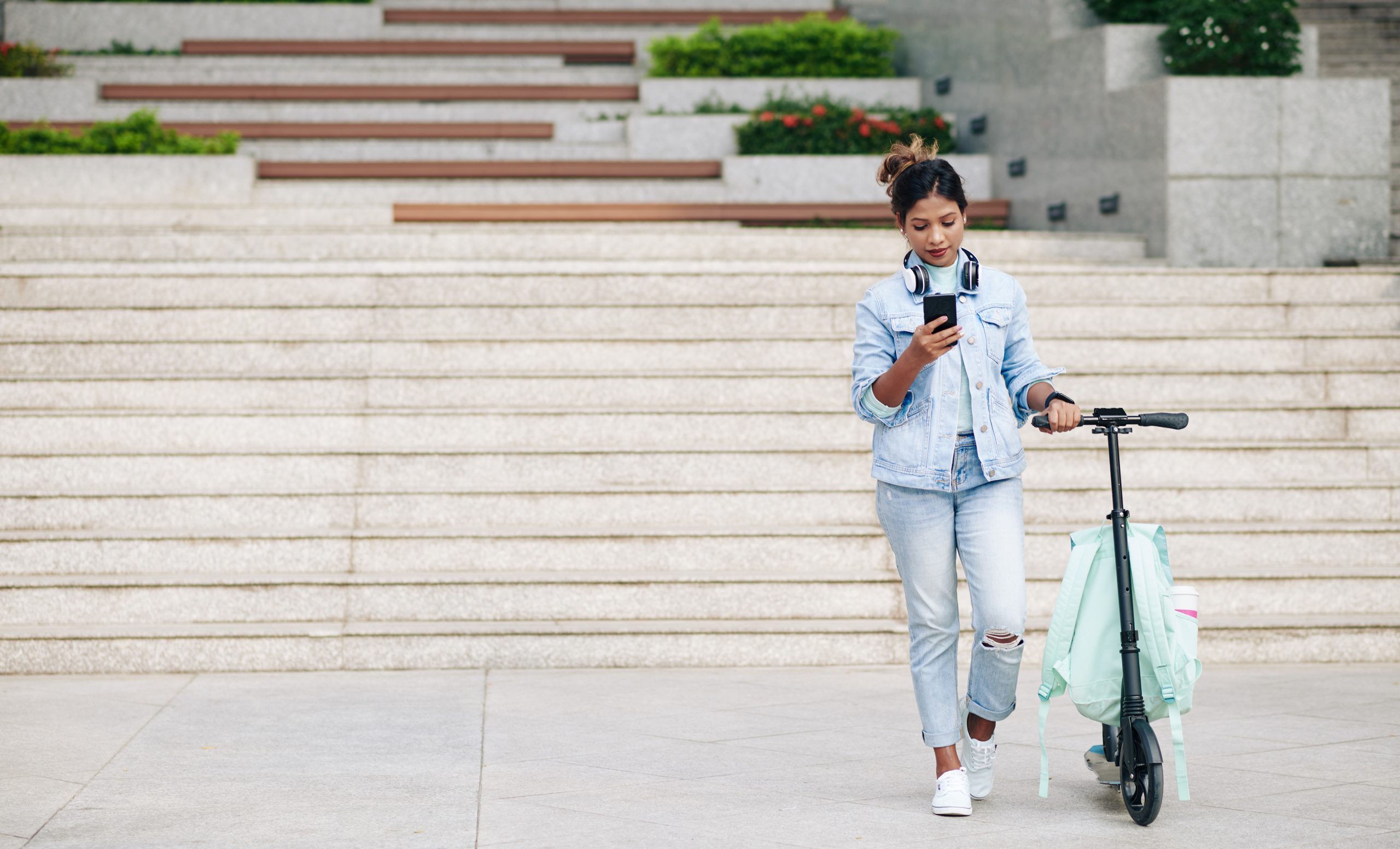 woman-standing-next-to-scooter