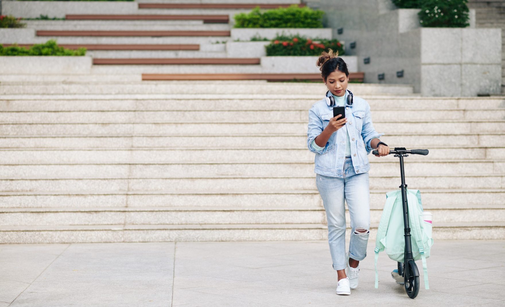 woman-standing-next-to-scooter
