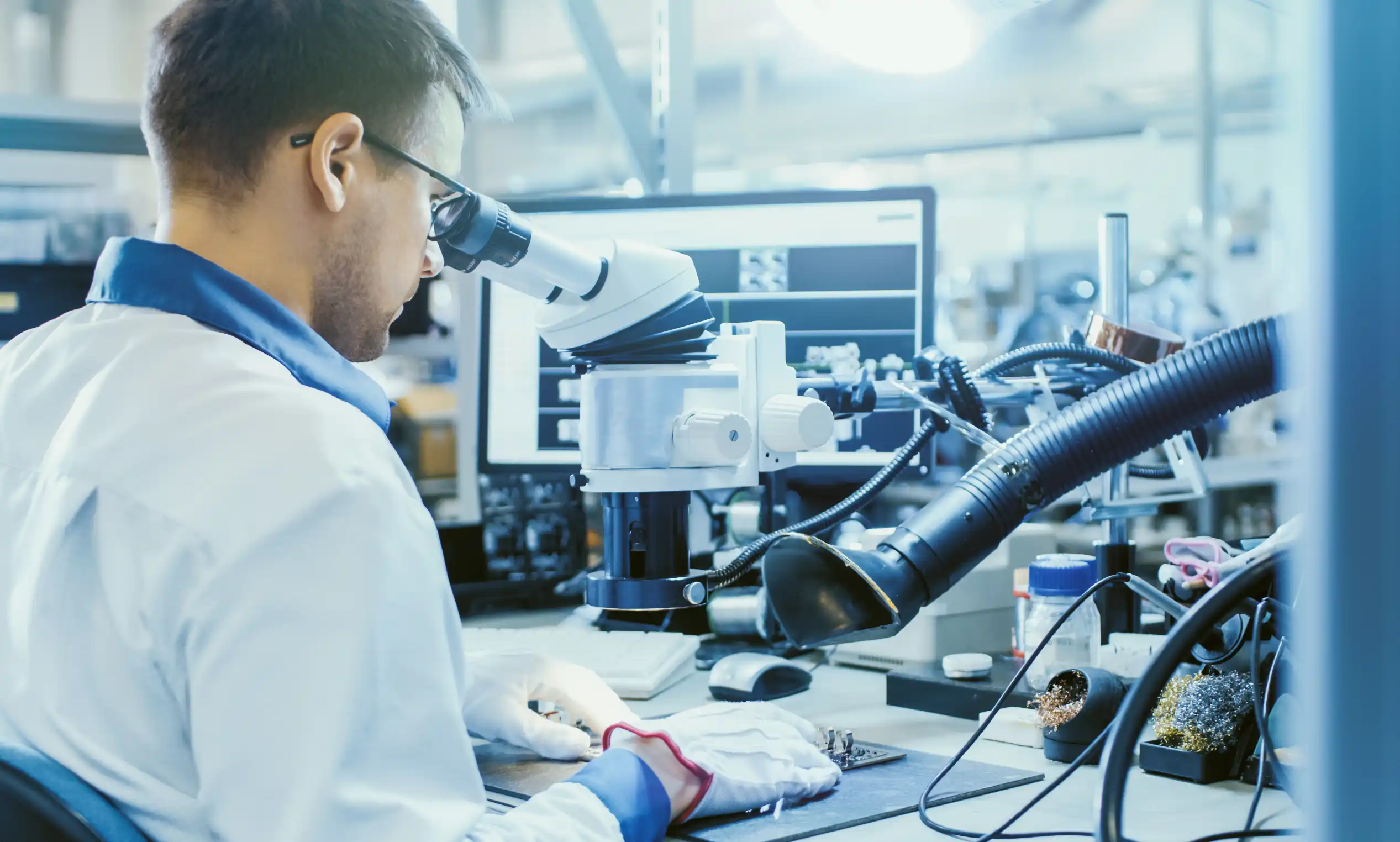 Electronics-technician Electronics technician inspecting a device